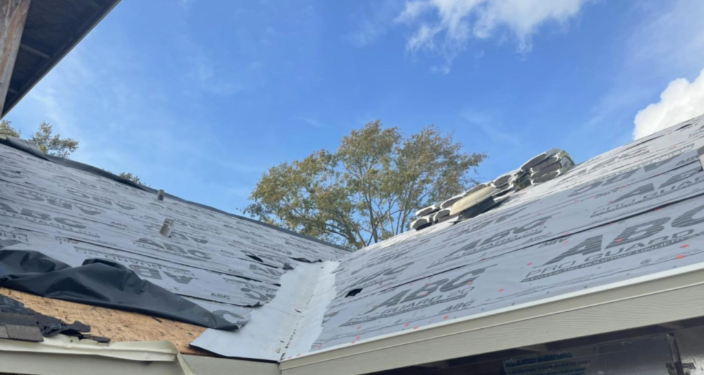 Shingle roof being installed on home.