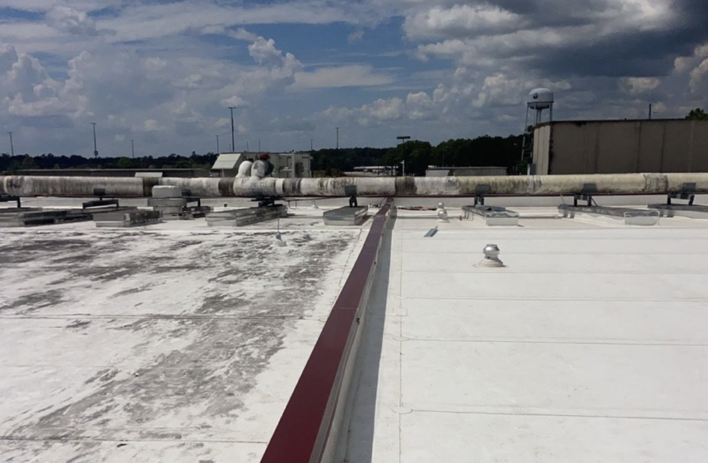 Half damaged/half restored commercial roof.